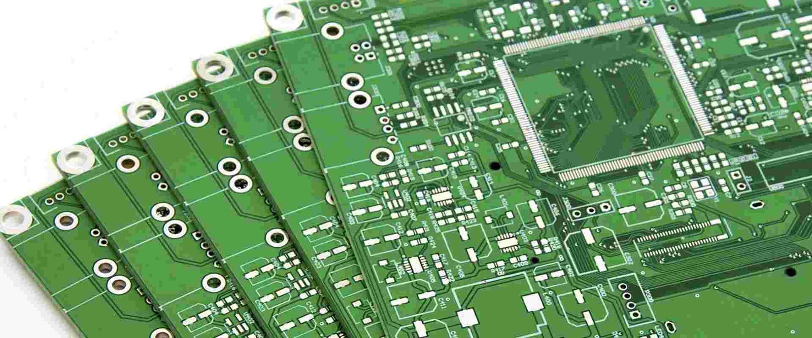 Group of green bare circuit-board samples with traces, pads and mounting holes