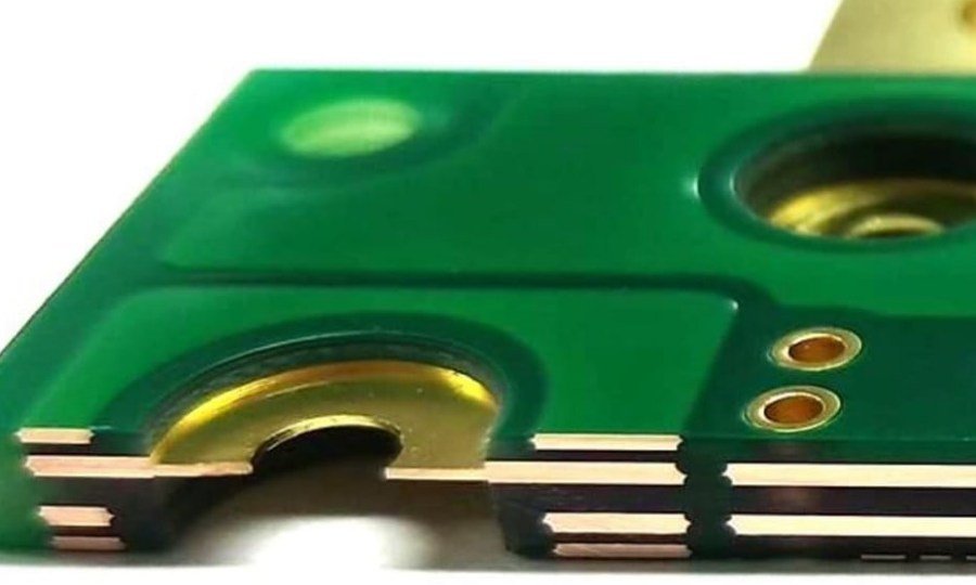 PCB copper edge detail | GlobalWellPCB Close-up of circuit-board edges, copper surfaces and a plated opening