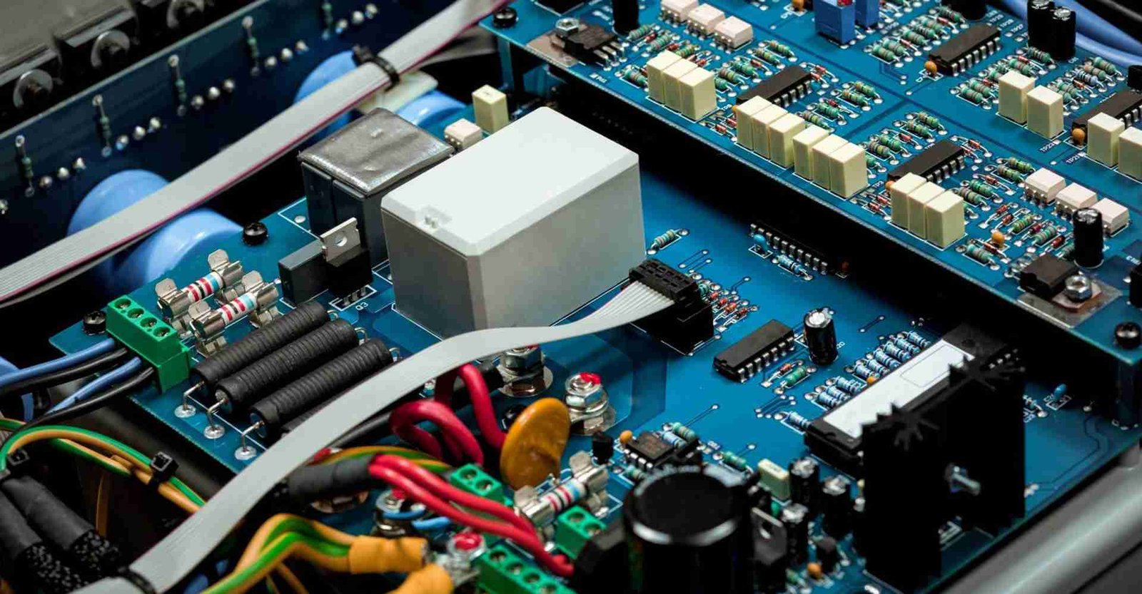 Electronic circuit-board assemblies installed inside an enclosure and connected by cables