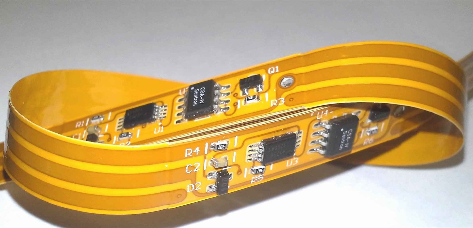Mounted electronic components on an amber flexible circuit bent into a loop