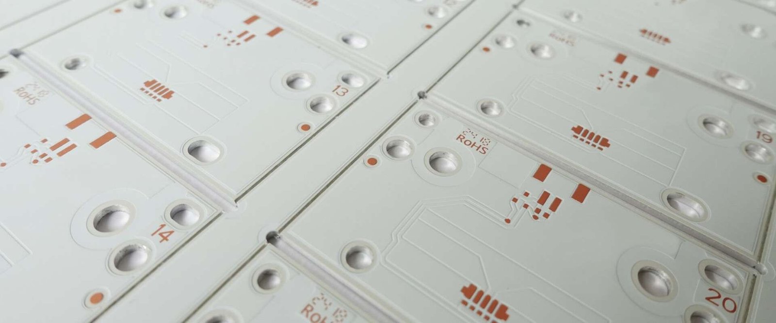 White lighting PCB panels | GlobalWellPCB White circuit-board panels with repeated lighting footprints and mounting holes