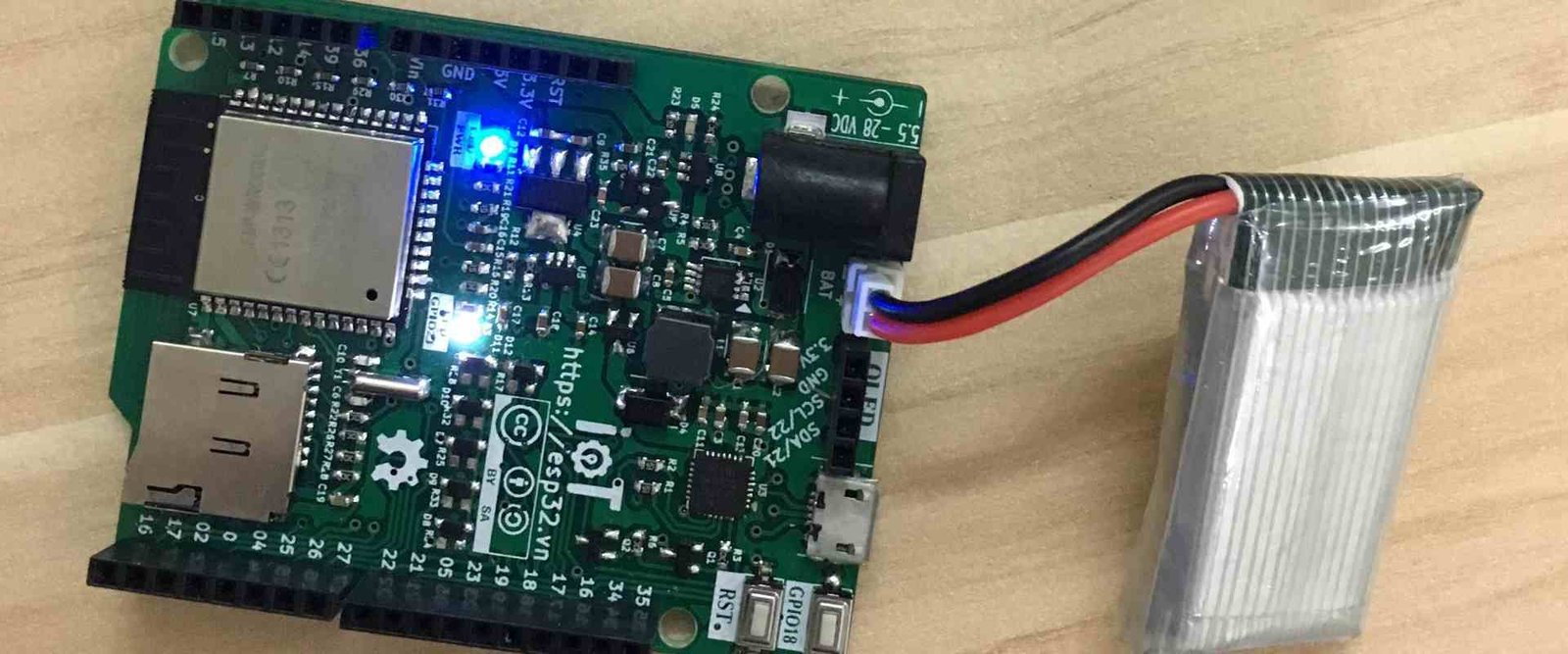 Small populated circuit-board module connected to a battery by wires