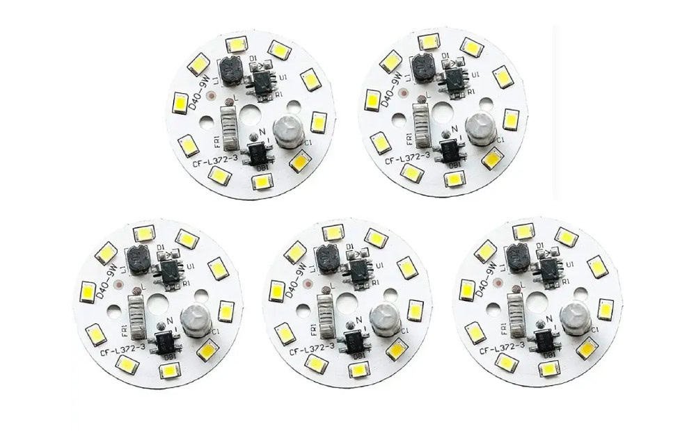Four white circular circuit boards populated with LEDs and small components