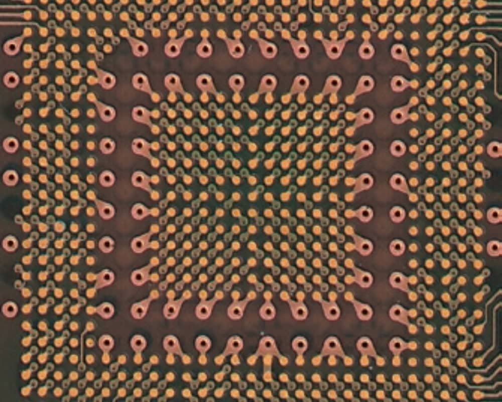 Dense PCB pad close-up | GlobalWellPCB Close-up of dense copper pads and small via openings on a circuit board