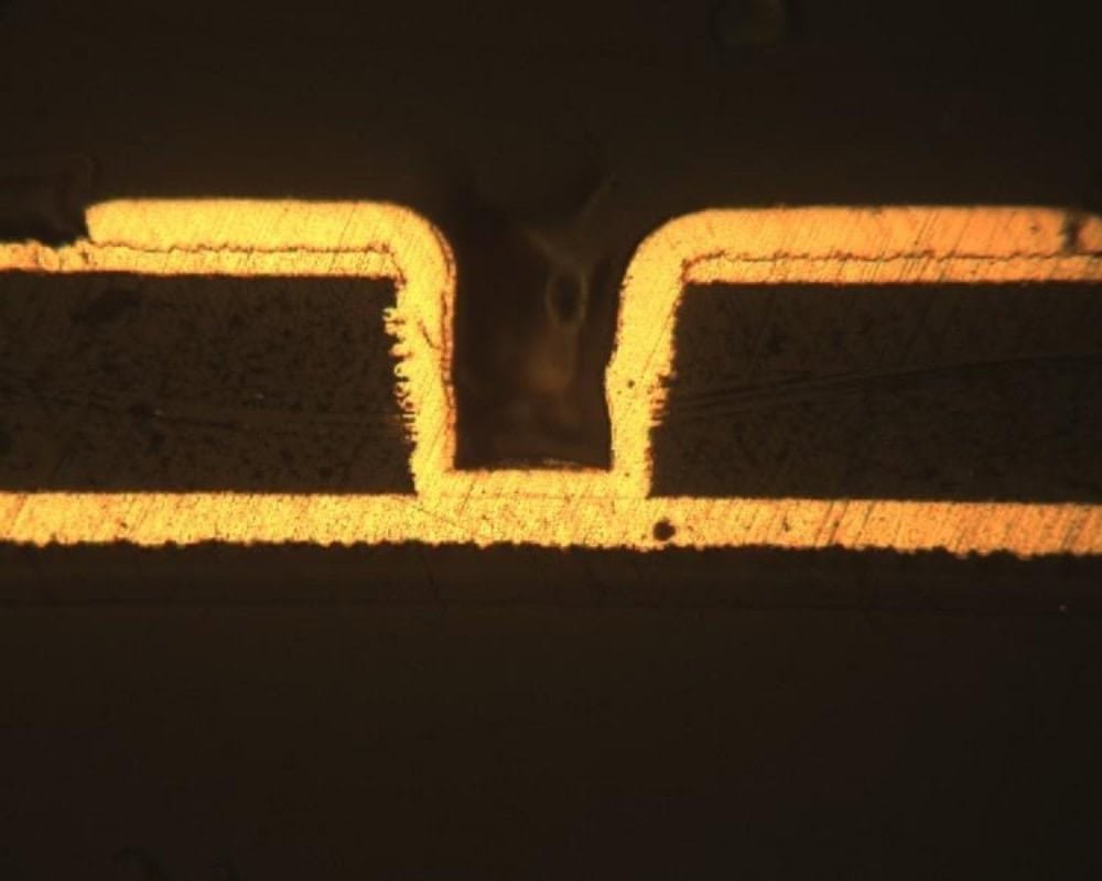 Microvia section photograph | GlobalWellPCB Magnified circuit-board cross-section showing a via connection through copper and dielectric layers