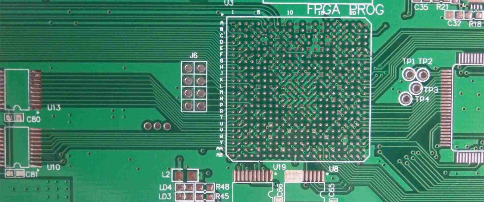 Dense circuit-board footprint | GlobalWellPCB Close-up of a large grid of contact pads and surrounding copper traces on a green board