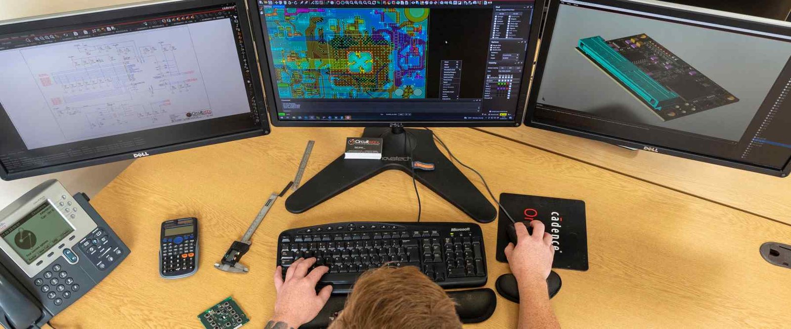 Workstation with circuit-design screens, a keyboard and sample circuit boards