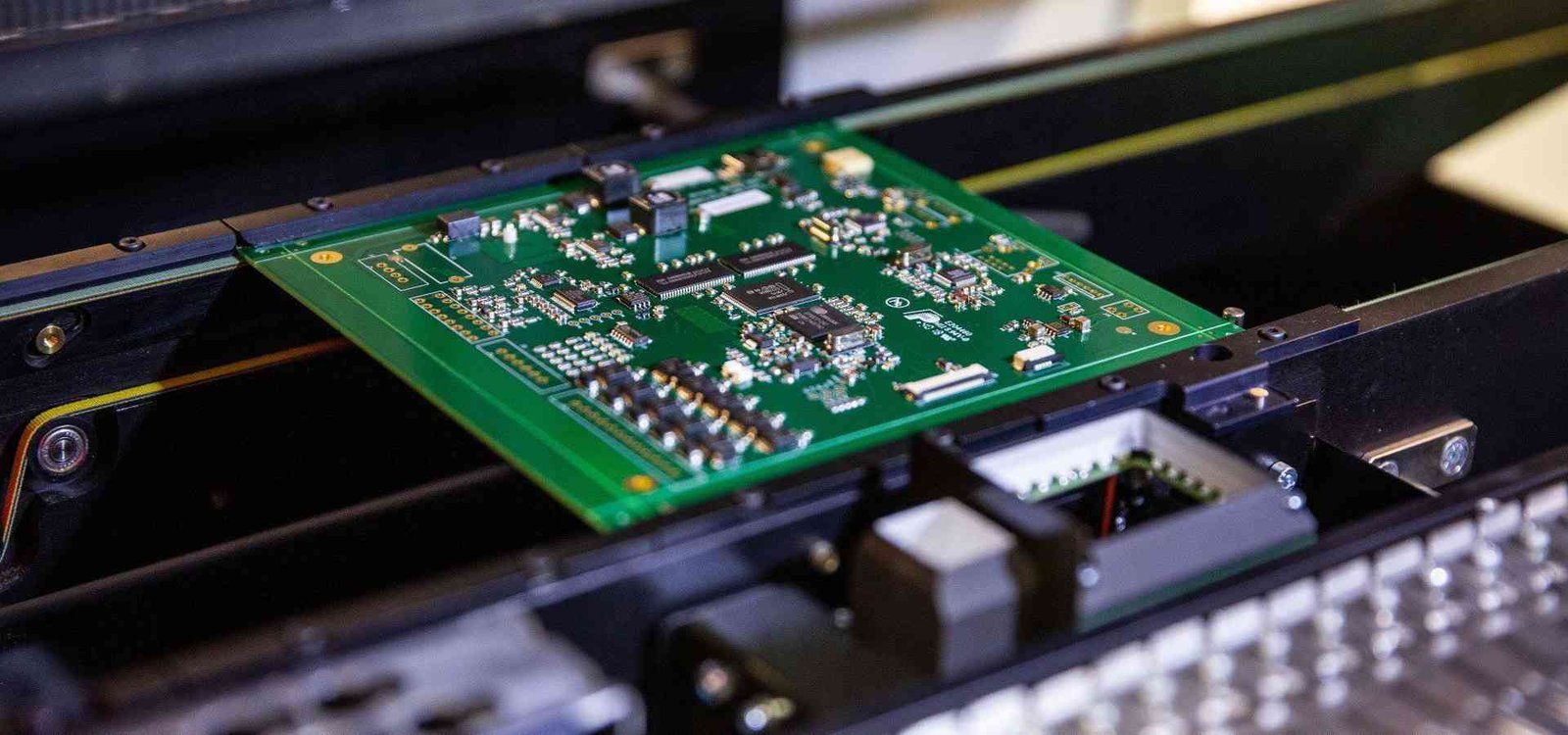 PCB assembly conveyor example | GlobalWellPCB Populated circuit-board assembly travelling through production equipment