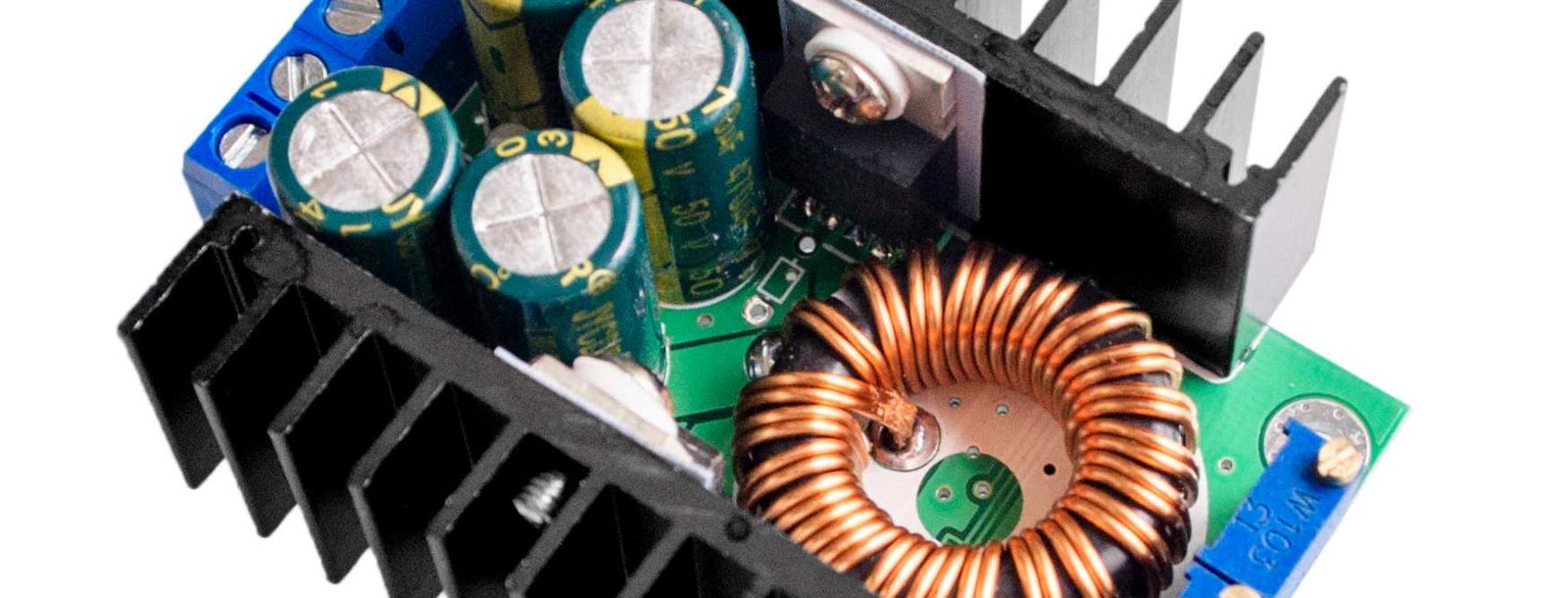 Power converter component detail | GlobalWellPCB Power converter assembly with a toroidal coil, large capacitors and heat sinks