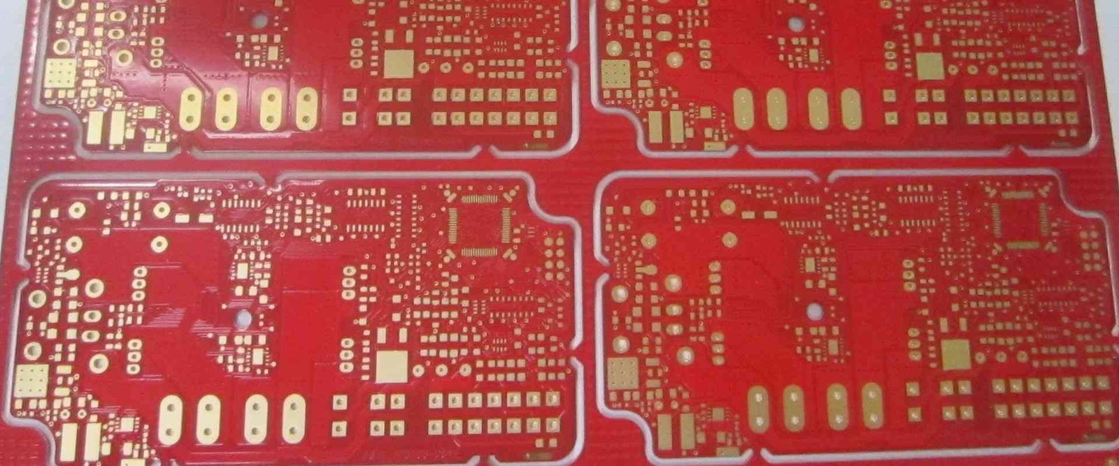 Red PCB panel | GlobalWellPCB Red bare circuit-board panel with repeated circuit patterns and contact pads