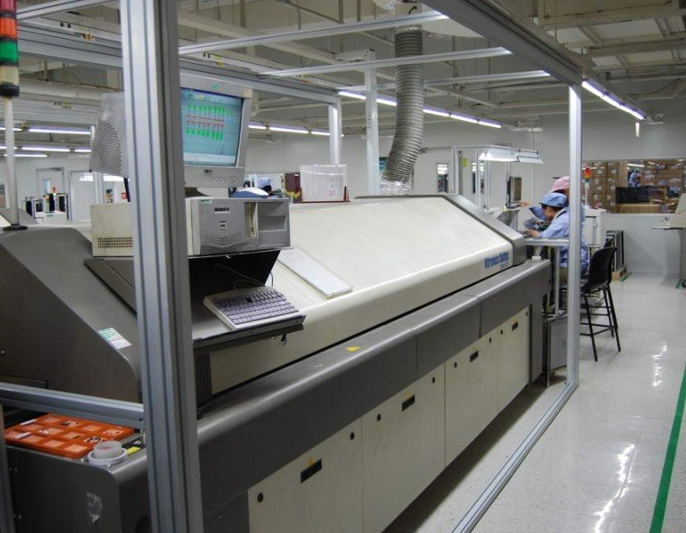 Reflow Soldering Oven | GlobalWellPCB Reflow soldering oven with conveyor access, a control monitor and exhaust ducting