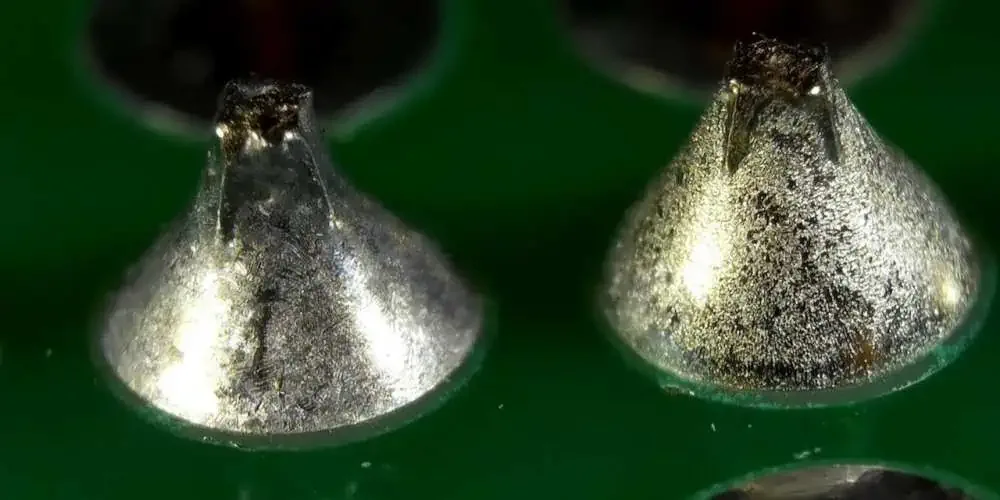 Solder-joint close-up | GlobalWellPCB Magnified view of two solder joints on a green circuit-board surface