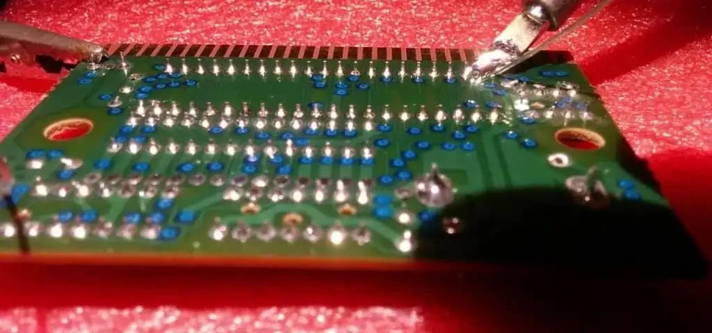 Close-up of rows of soldered through-hole terminals on a populated circuit board