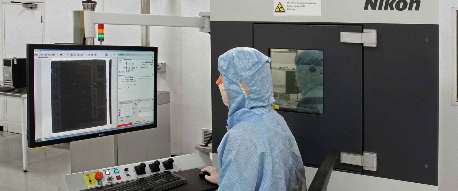 X-ray inspection workstation | GlobalWellPCB Operator standing beside an industrial X-ray inspection cabinet
