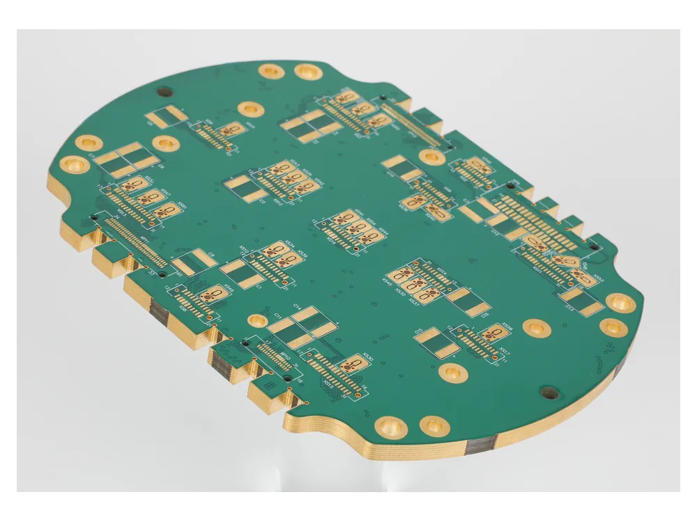 Angled green circuit board with gold-colored pads, mounting holes and a visible thick board edge.