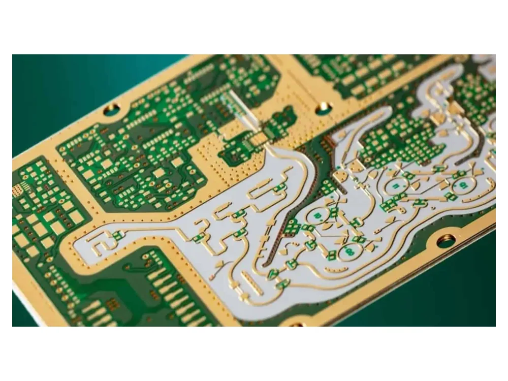 Close-up of RF PCB routing with shaped conductor patterns and mounting holes.